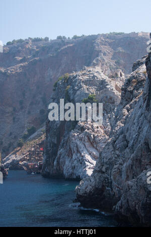 View from sea of Alanya castle rock with castle walls and remains of ancient monestary located on cape Jilvarda Stock Photo