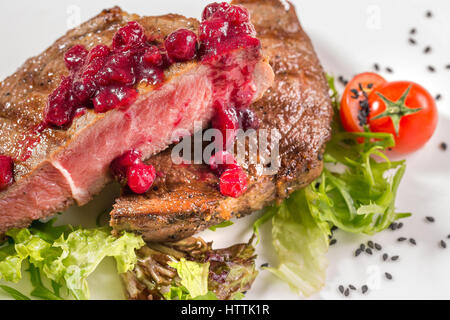 Large piece of fresh beef meat prepared on a grill pan. Toned. Portions thick beef juicy sirloin steaks on grill teflon pan or granite board. Stock Photo