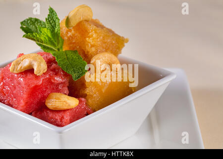 Various kinds of baby food in plastic bowls, top view. Assorted flavors of homemade fresh pureed frozen fruit popsicles sitting on white plate in a ro Stock Photo