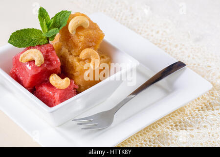 Various kinds of baby food in plastic bowls, top view. Assorted flavors of homemade fresh pureed frozen fruit popsicles sitting on white plate in a ro Stock Photo