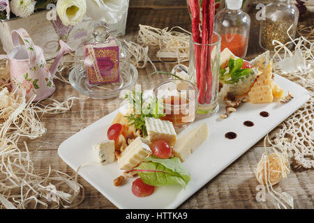 Cheese heaven. Cheese Mix Cheese brie, gouda cheese, blue cheese, cheese parmezan, orange cheese on a wooden board Stock Photo