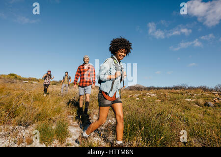 Group of young friends hiking in countryside. Multiracial happy people  travelling in nature Stock Photo