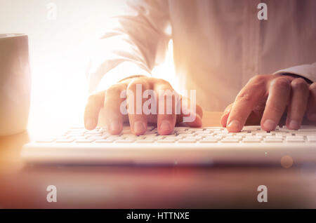 Businessman typing on computer keyboard at office. Concept for business and technology, can be used for website banner, printed material, advertising. Stock Photo