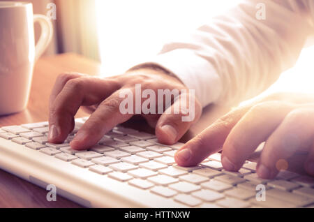 Close up of man’s hands typing on keyboard. Concept for business and technology, can be used for website banner, printed material, advertising. Stock Photo