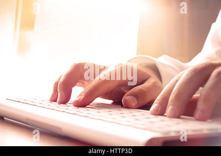 Man’s hands typing on computer keyboard. Concept for background, website banner, promotional materials, poster, presentation templates, advertising an Stock Photo