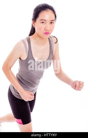 Teenage Asian girl jogging on white background Stock Photo