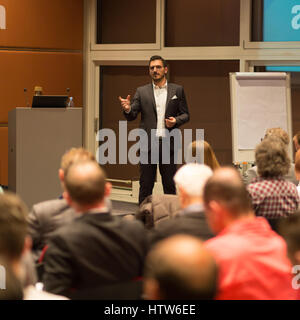 Business speaker giving a talk in conference hall. Stock Photo
