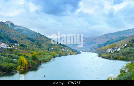 Douro river, wineyards and villages with cloudy sky. Porto province. Portugal Stock Photo