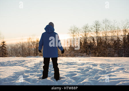 Man standing on snowy landscape Stock Photo