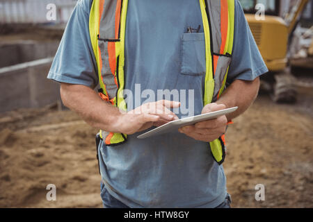Construction worker using digital tablet Stock Photo