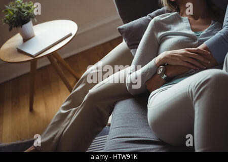 Romantic couple embracing each other on sofa Stock Photo
