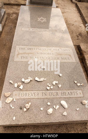 Gravestone epitaph for a loved woman. Stones are left by visitors at a Jewish grave. Stock Photo