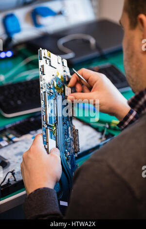 Man repairing laptop Stock Photo