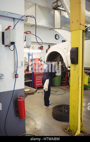Mechanic examining a car wheel disc brake Stock Photo