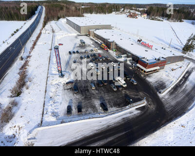 NUIJAMMAA, FINLAND - CIRCA FEB, 2017: Huge building of shopping mall of the Laplandia market is located on Russian-Finnish border. Aerial view at wint Stock Photo
