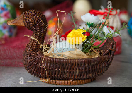 Decorated wicker basket with eggs and flowers. Easter Stock Photo