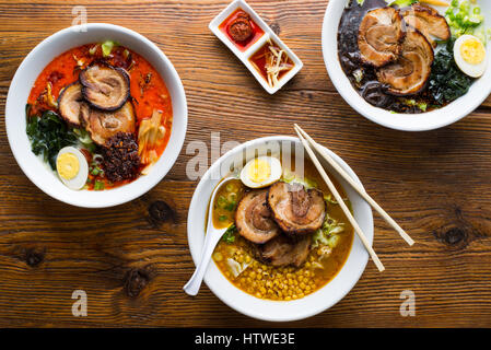 Horizontal view of ramen noodles being pulled up by chopsticks. Stock Photo