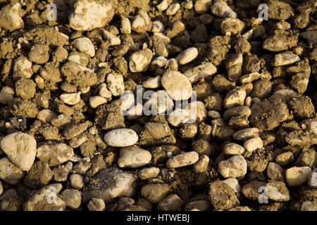 Gray muddy pebbles on the ground ready for construction of the road Stock Photo