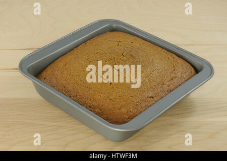 Baked gingerbread cake in baking pan on table Stock Photo