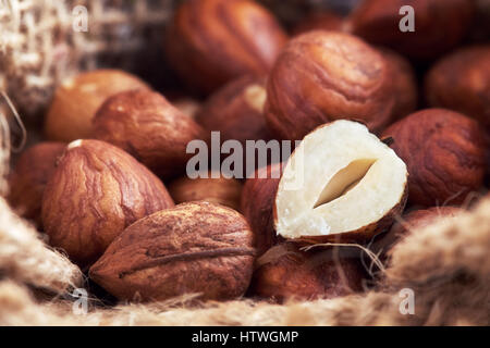 Peeled hazelnuts in burlap bag, close-up with selective focus Stock Photo