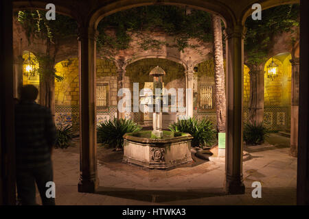 Spain, Barcelona, courtyard and fountain of Casa de l’Ardiaca House (Archdeacon's House) at night in Gothic Quarter (Barri Gotic), Historic Archive of Stock Photo
