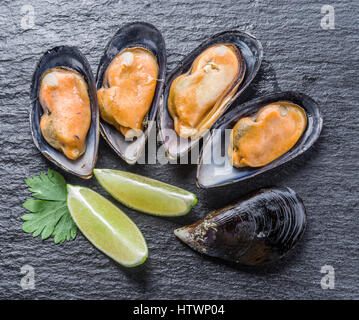Boiled mussels on the graphite background.