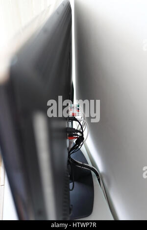 Various cables in the back of a LCD TV Stock Photo