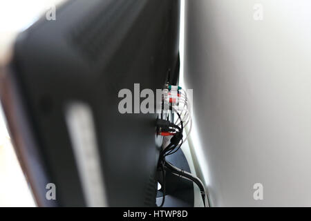 Various cables in the back of a LCD TV Stock Photo