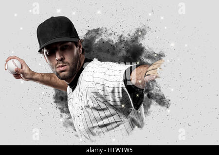 Baseball Player with a white uniform coming out of a blast of smoke . Stock Photo
