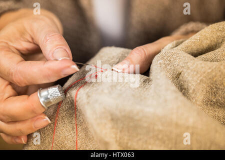 Woman sewing cloth Stock Photo