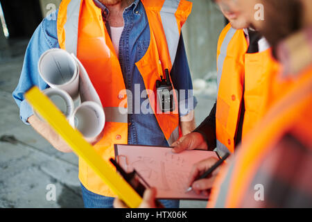 Constructors planning work or discussing new building project Stock Photo