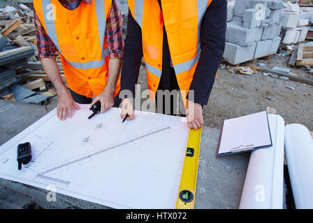 Two contractors discussing sketch of new building Stock Photo