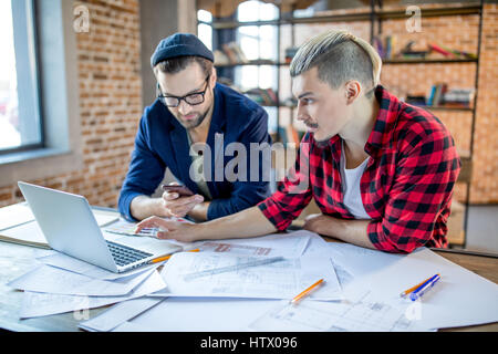 Architects using laptop and smartphone  Stock Photo