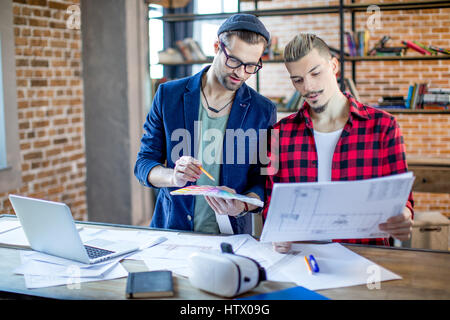 Architects discussing blueprints  Stock Photo