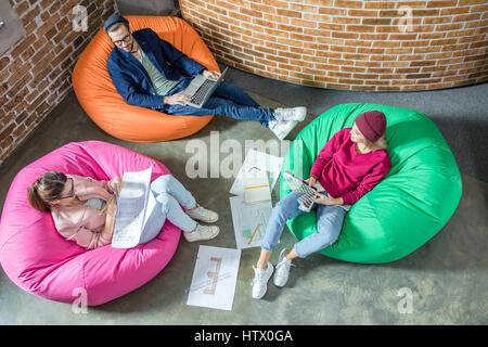 People in bean bag chairs Stock Photo