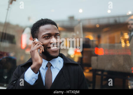 Mobile entrepreneur with cellphone talking in the city Stock Photo