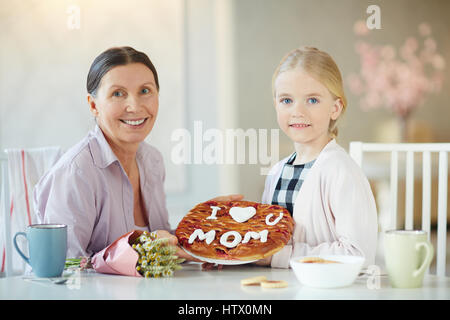 Girl and her grandmother holding homemade holiday pie Stock Photo