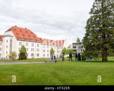 Lindau, Germany - May 2, 2015: Participants in a Turkish wedding as they walk in the park of Lindau. The photographer takes pictures to remember the e Stock Photo