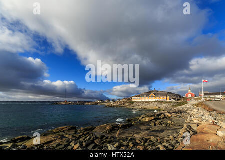 View from the old harbor, church of Our Saviour and Greenlandic flag in the background, historical center of Nuuk Stock Photo