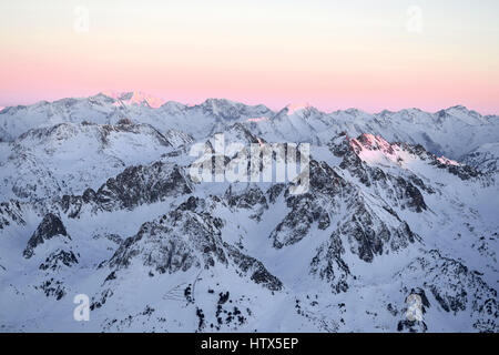 Amazing winter sunset views of the mountain landscape, from Pic Du Midi in the French Pyrenees.  spectacular coloured sky Stock Photo