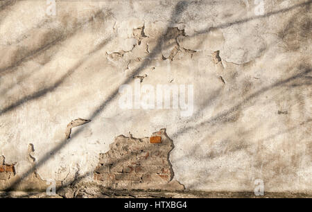 Background, wall of old house with cracked plaster Stock Photo
