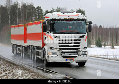 SALO, FINLAND - MARCH 10, 2017: White customized Scania R730 combination vehicle of Transport Stromberg trucking along rural highway on a rainy day in Stock Photo