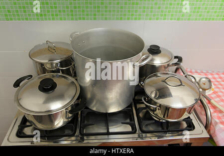 large and small pots in the industrial kitchen on the stove inside the restaurant during the preparation of food Stock Photo