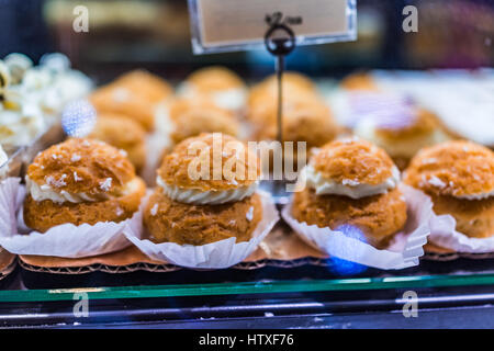 Whipped cream puffs on display in bakery Stock Photo