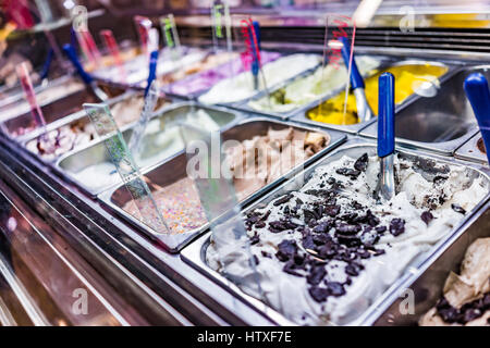 Ice cream serving counter with many scoopable flavors Stock Photo