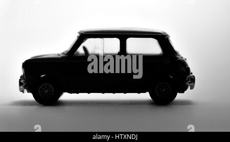Die cast model of a mini cooper shot in a black and white silhouette. Stock Photo