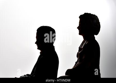 Miniature figurine pensioner couple facing left in silhouette. Stock Photo