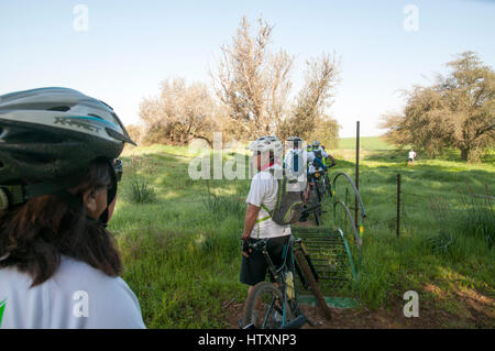 A group of leisure cross contry cyclists with protective clothing. Photographed Negev Desert, Israel Stock Photo