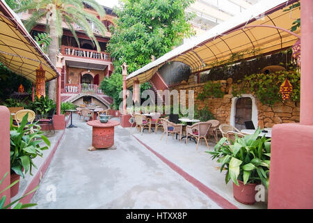 PALMA DE MALLORCA, SPAIN - AUGUST 8, 2016: Hostal Corona decorated and cozy courtyard with bar on August 8, 2016 in Puerto Portals, Mallorca, Spain. Stock Photo