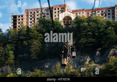 Derelict and rundown aerial old tram ropeway or cable car leading to the abandoned area in Chiatura. Industrial landmark of Georgia. Stock Photo